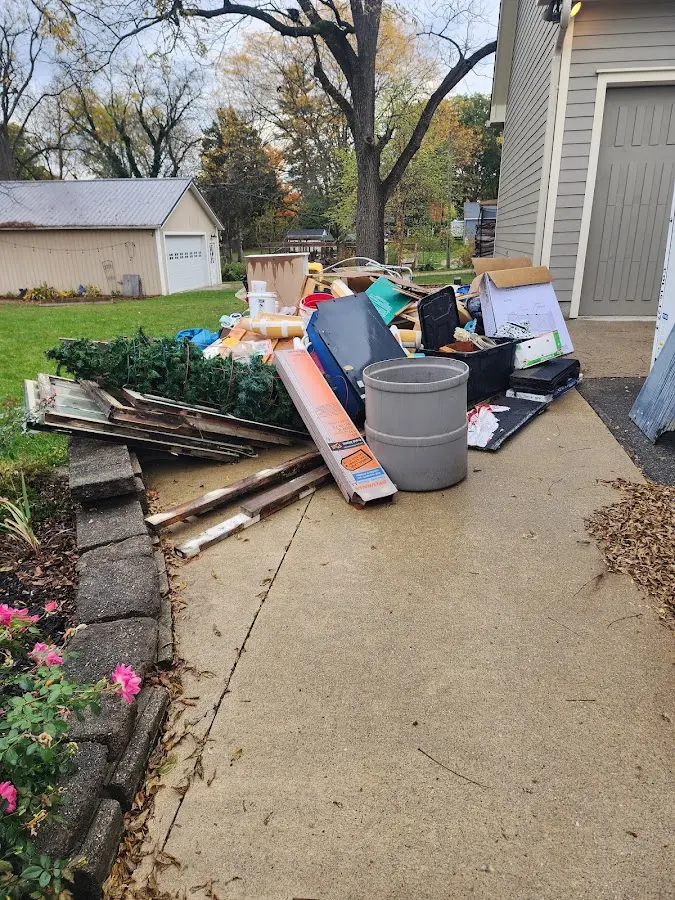 Dumpster being loaded with debris for Estate Cleanout Dumpster Rental in Orange
